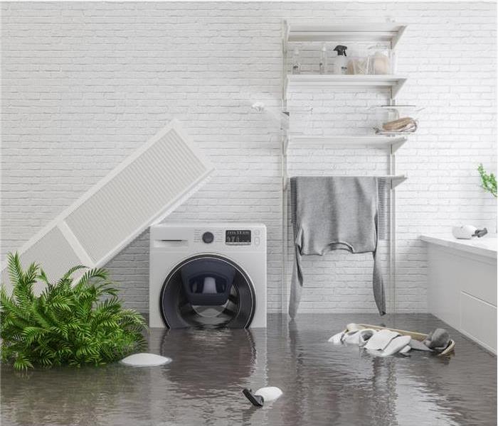 A white washing machine partially submerged in standing water in a flooded bathroom or laundry room.